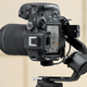A camera mounted in a vertical, portrait-mode orientation on the DJI RS 3 Mini stabilizer.